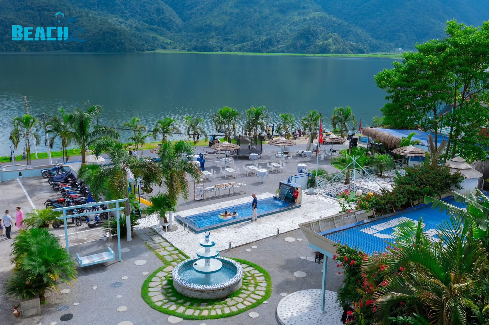 The Beach grounds, palms and pool on the shores of Phewa Lake