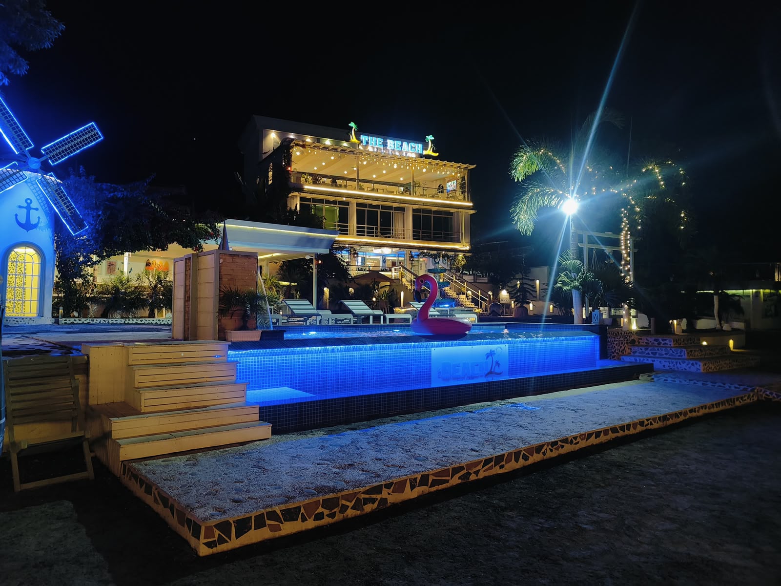 The Beach lodge and pool illuminated at night